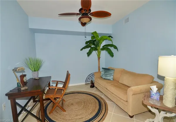 a living room with furniture and a potted plant