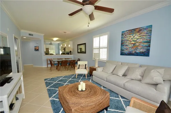a living room with furniture a dining table and a fireplace