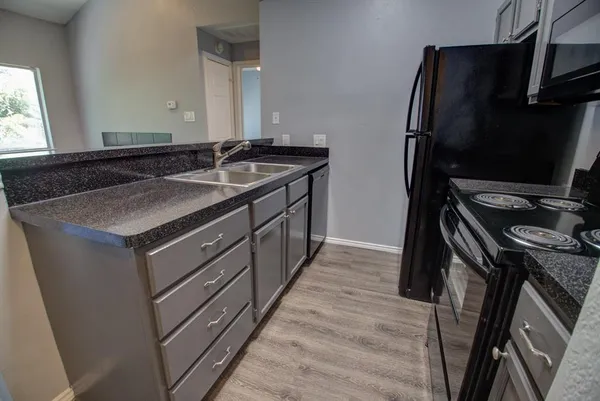 a kitchen with a sink stove and refrigerator
