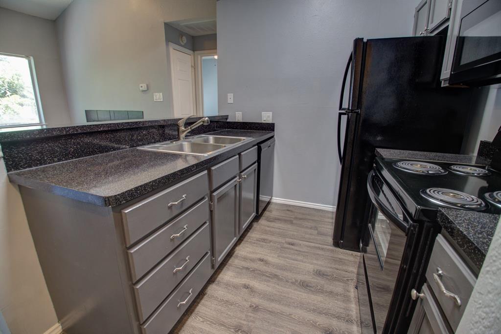 a kitchen with a sink stove and refrigerator