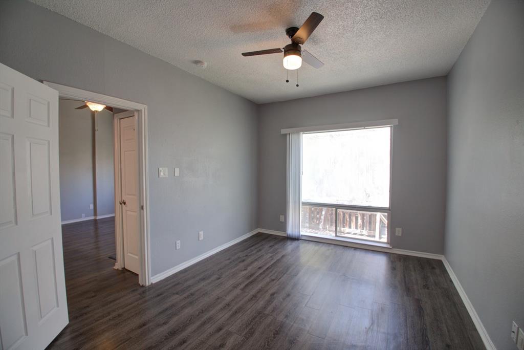 2606 Rio Grande Street, Unit 305 Austin, TX 78705 - Photo 15 of 18 an empty room with wooden floor fan and windows