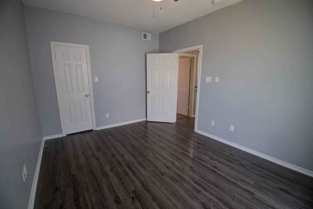 2606 Rio Grande Street, Unit 305 Austin, TX 78705 - Photo 16 of 18 a view of an empty room with wooden floor and a window