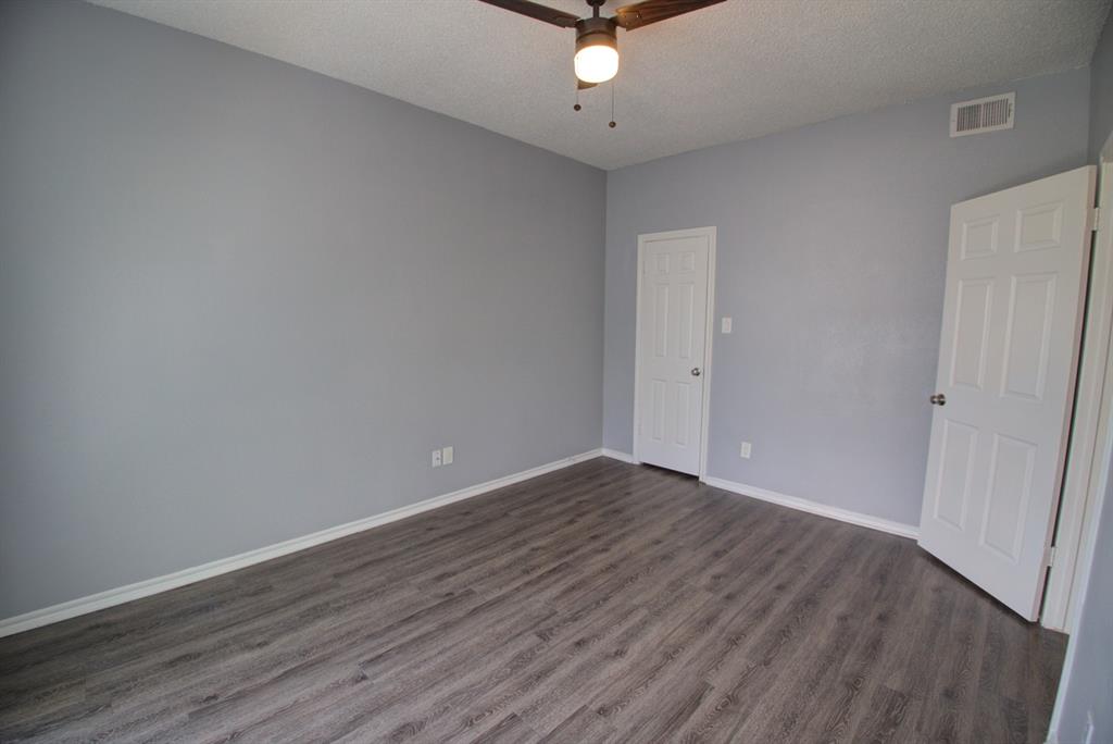2606 Rio Grande Street, Unit 305 Austin, TX 78705 - Photo 17 of 18 a view of an empty room with wooden floor
