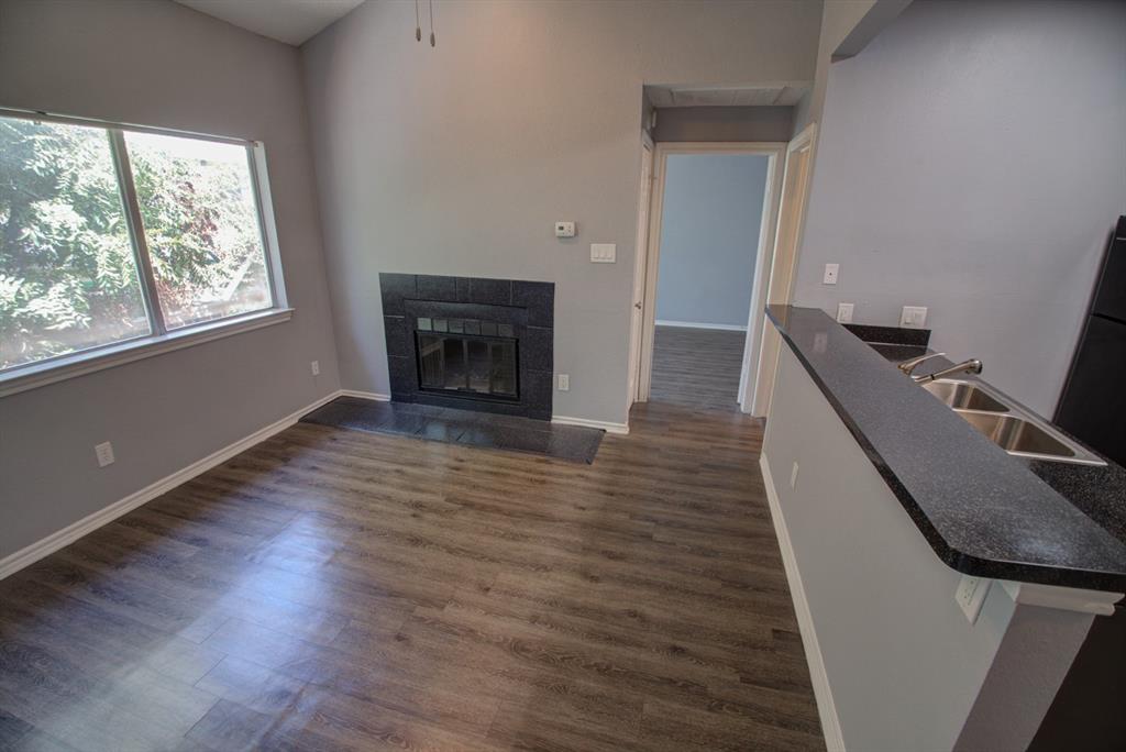 2606 Rio Grande Street, Unit 305 Austin, TX 78705 - Photo 5 of 18 a view of a livingroom with wooden floor and a fireplace