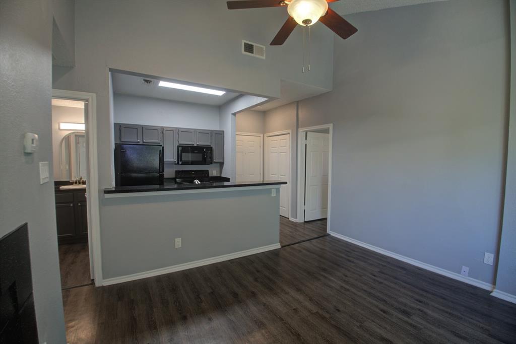 2606 Rio Grande Street, Unit 305 Austin, TX 78705 - Photo 6 of 18 a view of a kitchen with a sink wooden floor and cabinets