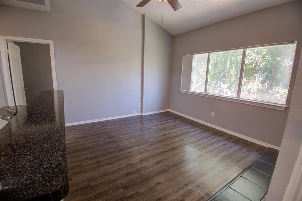 2606 Rio Grande Street, Unit 305 Austin, TX 78705 - Photo 9 of 18 a view of an empty room with wooden floor and a window