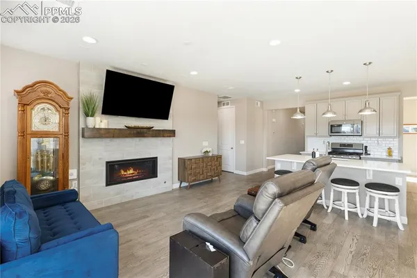 a living room with furniture fireplace and flat screen tv