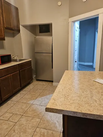 a kitchen with stainless steel appliances granite countertop a sink and a stove top oven