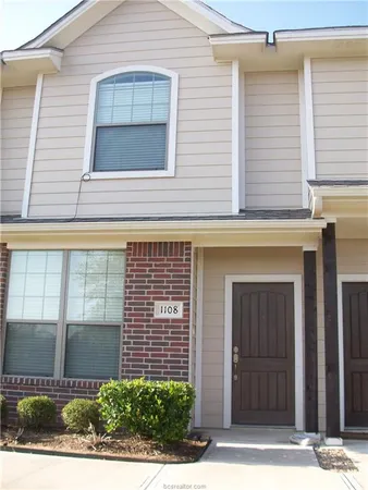 a view of a brick house with windows