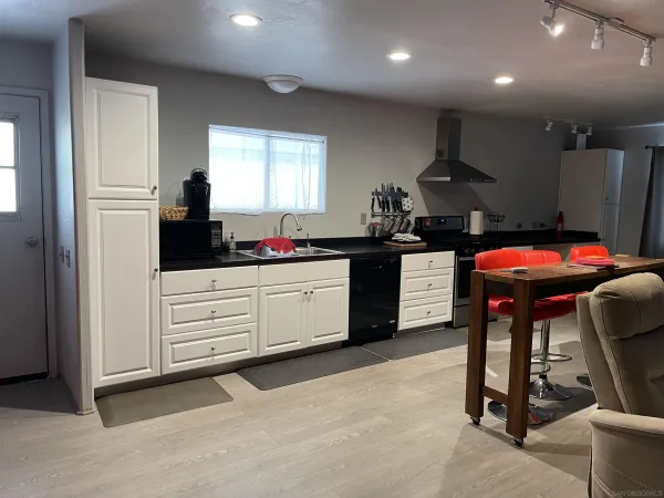 a kitchen with a sink cabinets and window