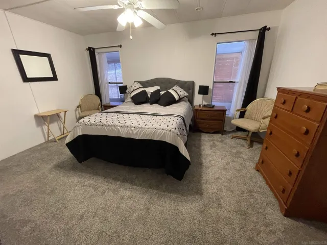 a bedroom with a bed and a mirror