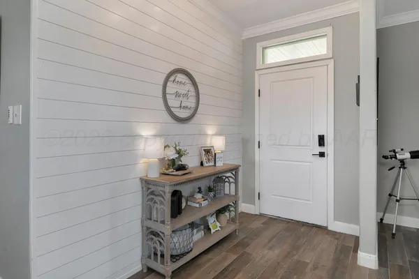 a large kitchen with cabinets a sink and chairs
