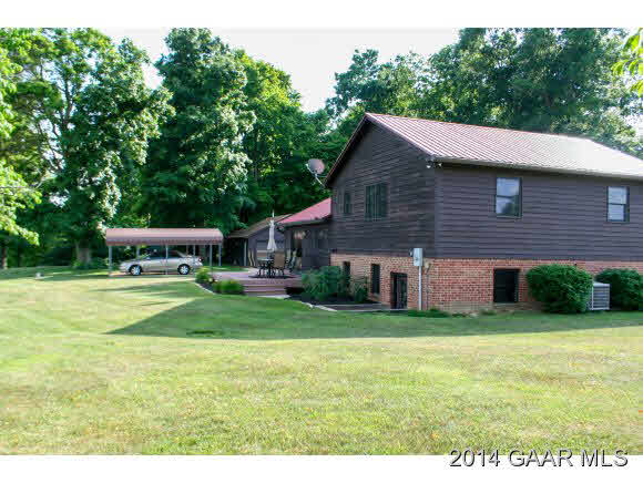 1462 Old Providence Road Raphine, VA 24472 - Photo 3 of 30 a aerial view of a house next to a big yard and large trees
