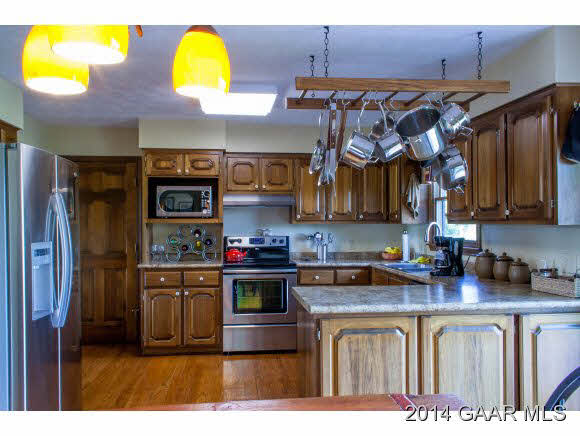 1462 Old Providence Road Raphine, VA 24472 - Photo 6 of 30 a kitchen with stainless steel appliances granite countertop a stove a sink and a microwave