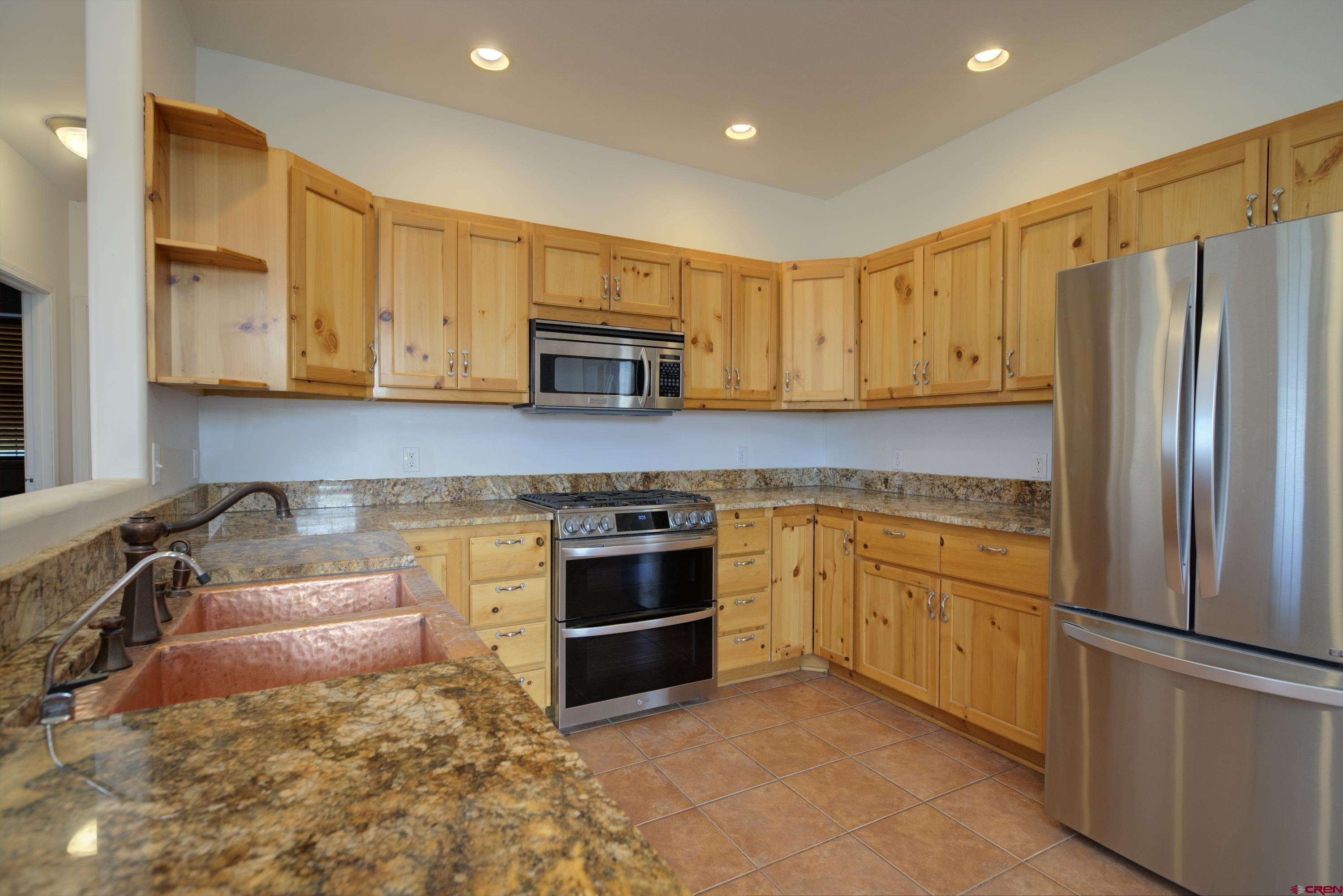 777 County Road 977 Ignacio, CO 81137 - Photo 13 of 45 a kitchen with stainless steel appliances granite countertop a refrigerator sink and stove