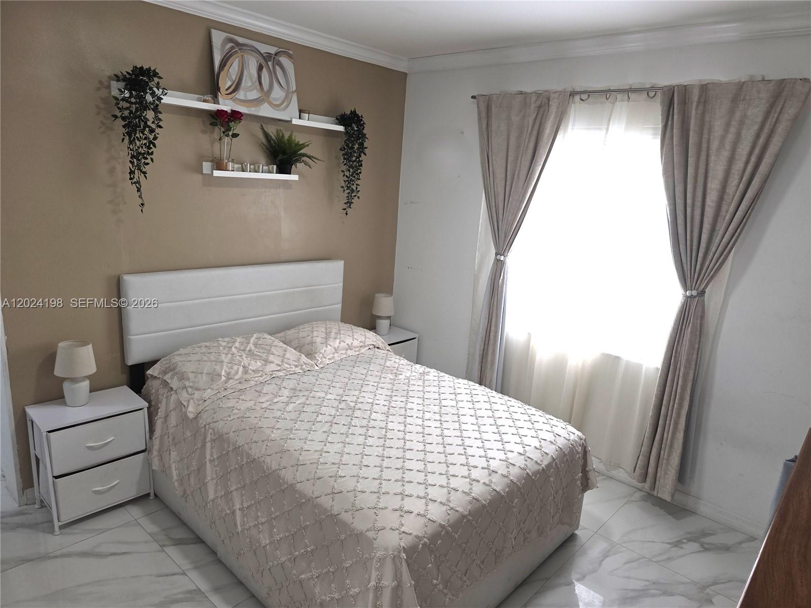 651 East 48th Street Hialeah, FL 33013 - Photo 13 of 52 a bedroom with a bed and a window
