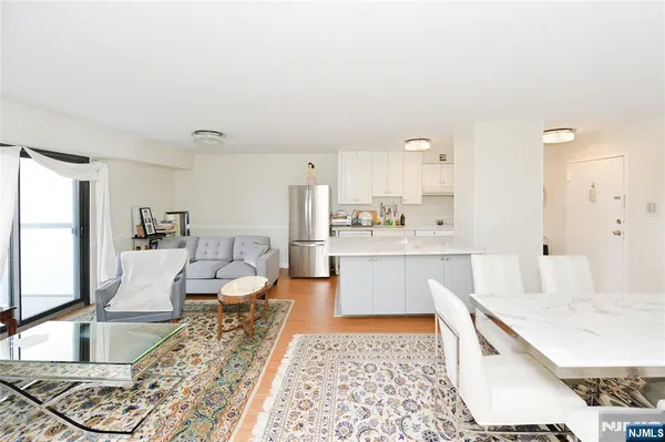 a large living room with stainless steel appliances kitchen island granite countertop furniture and a kitchen view