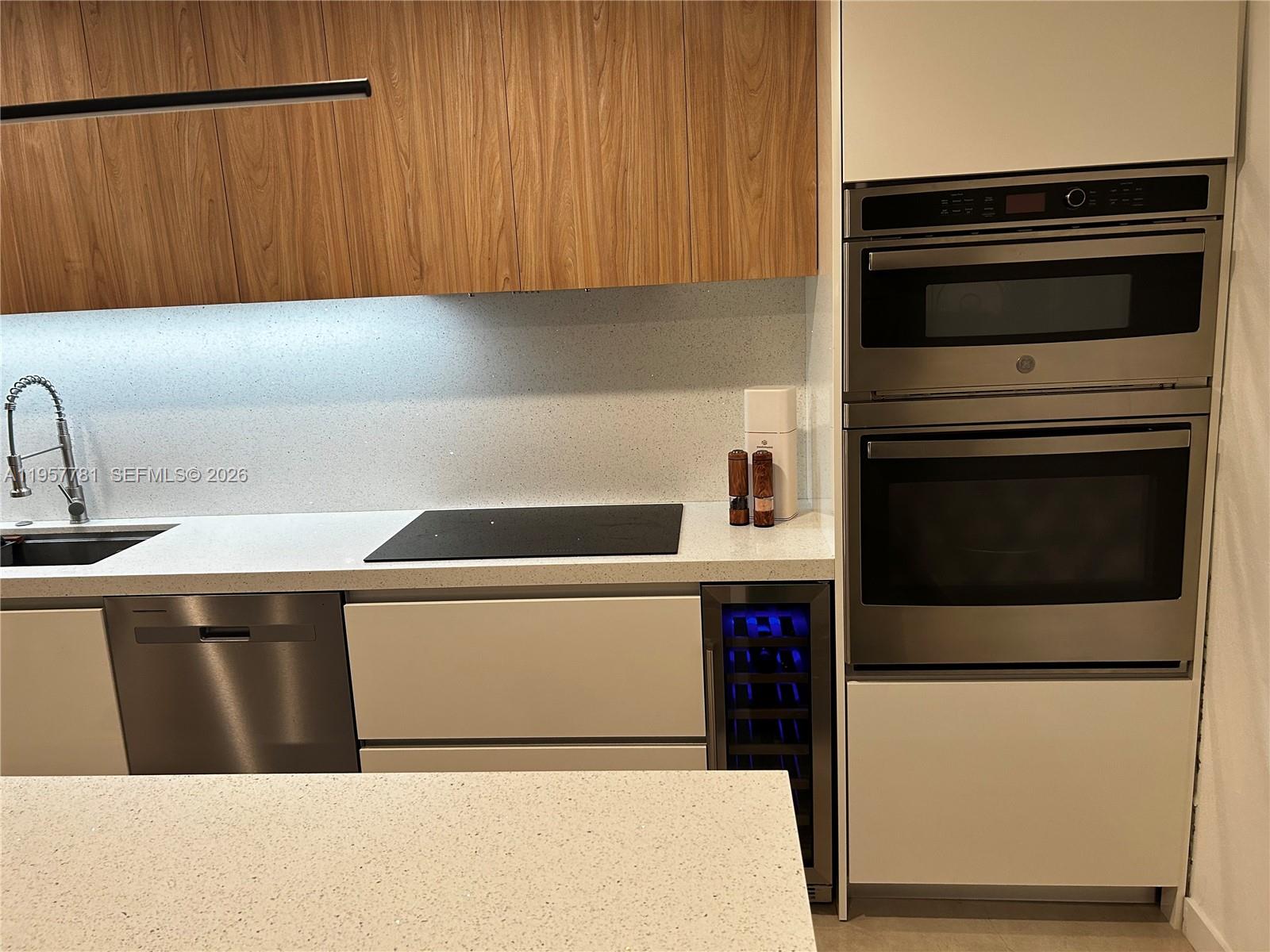14569 Southwest 261st Terrace, Unit 14569 Homestead, FL 33032 - Photo 13 of 29 a kitchen with a refrigerator sink and cabinets