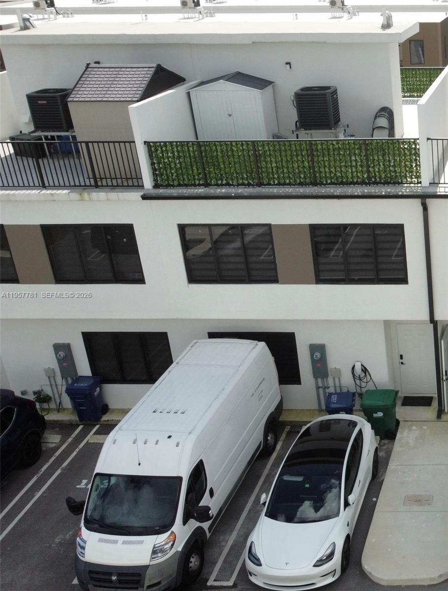 14569 Southwest 261st Terrace, Unit 14569 Homestead, FL 33032 - Photo 23 of 29 a white car parked in front of a building