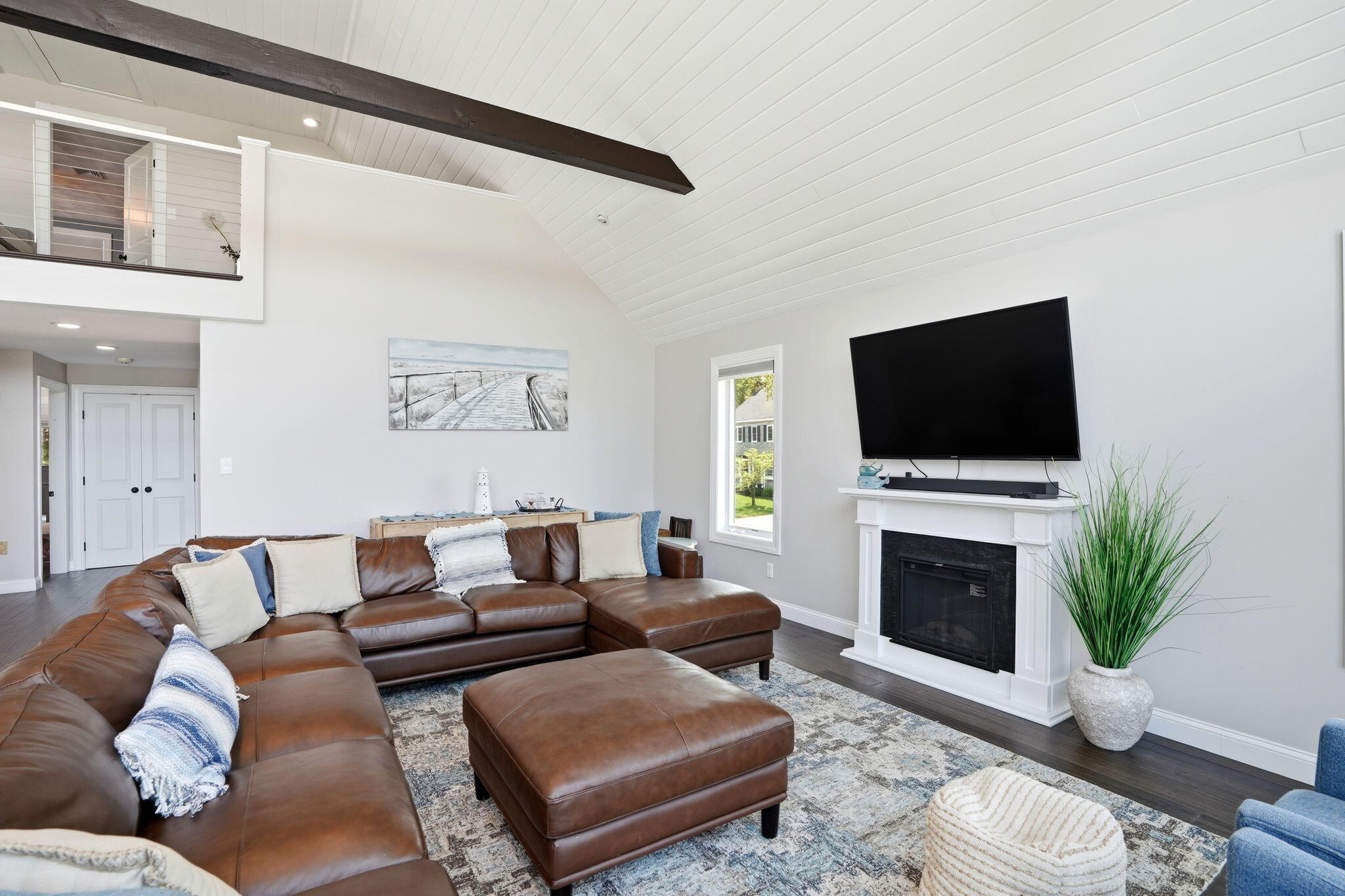 4 Cross Road Bourne, MA 02532 - Photo 12 of 47 a living room with furniture a fireplace and a flat screen tv