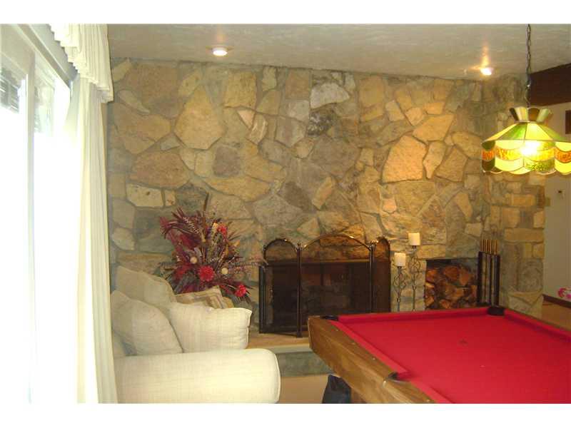 1022 Wren Drive McKees Rocks, PA 15136 - Photo 7 of 21 Family Room. Sunken family room with entire stone wall with gas fireplace opens to living room.