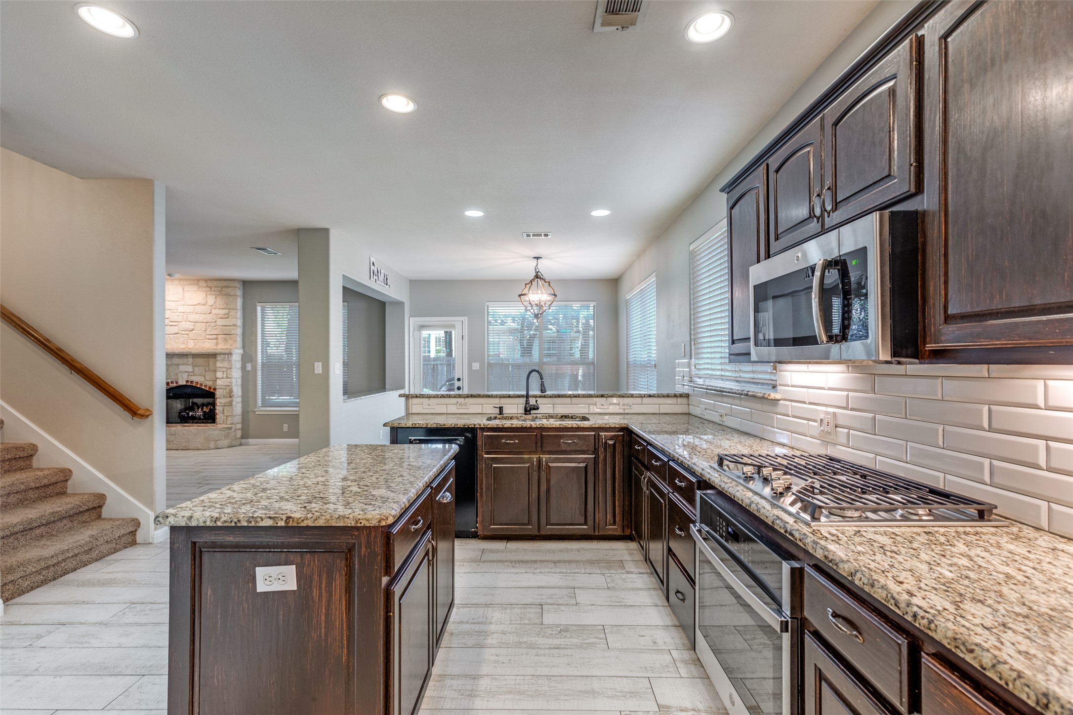 3729 Galena Hills Loop Round Rock, TX 78681 - Photo 13 of 33 a kitchen with granite countertop kitchen island stainless steel appliances a sink stove and cabinets
