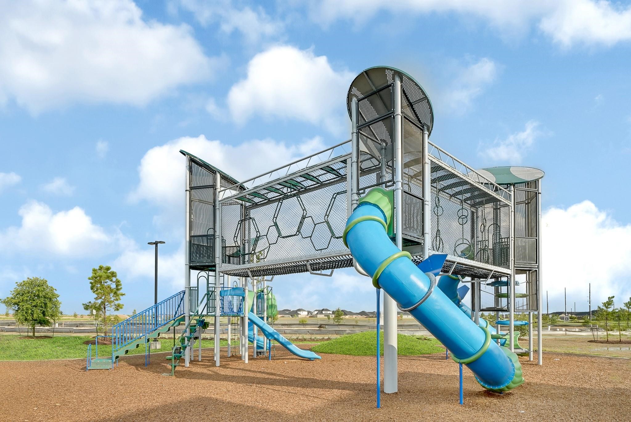 31423 Harp Ridge Drive Fulshear, TX 77441 - Photo 40 of 45 Modern playground featuring an exciting multi-level climbing structure and slides, perfect for family fun and outdoor activities.