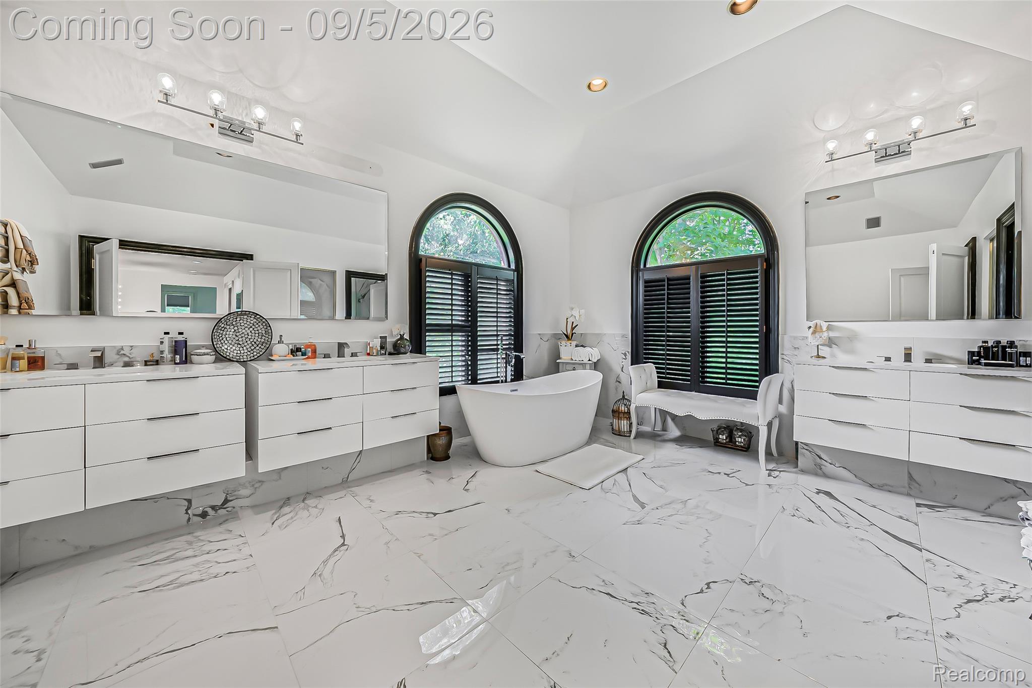 2785 Cranbrook Ridge Court Rochester, MI 48306 - Photo 41 of 97 Freestanding soaking tub, dual floating vanities with ample storage, large format floor tiles, and dual arched windows with plantation shutters