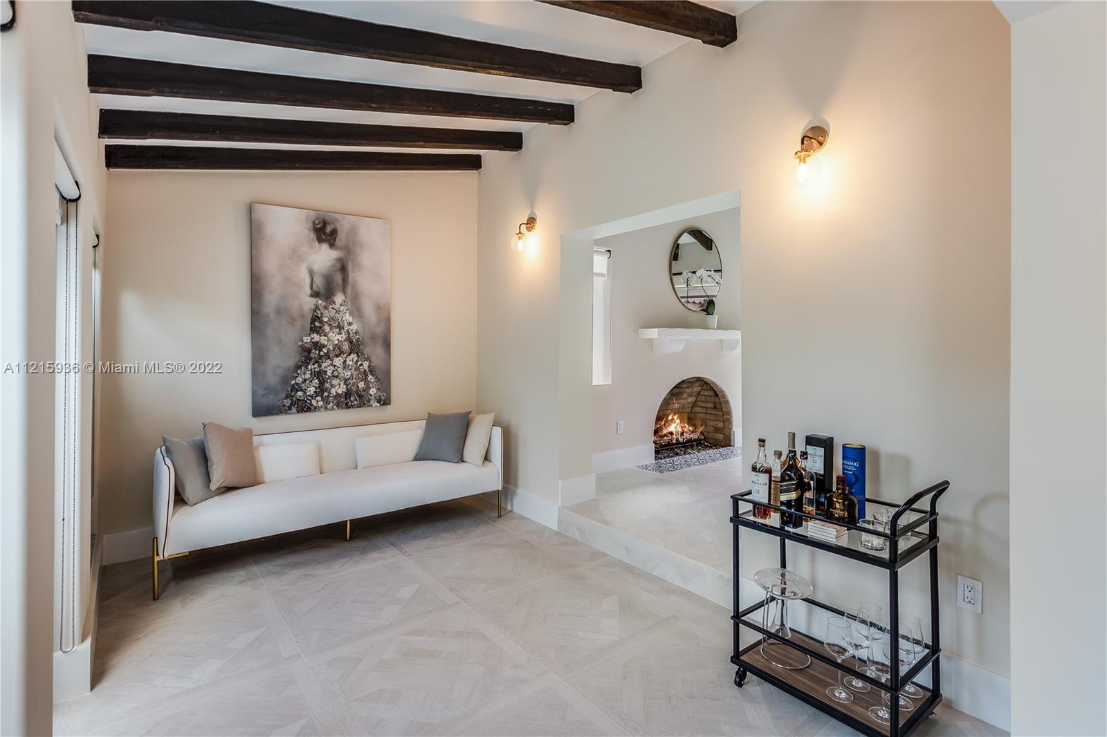 5135 Alton Road Miami Beach, FL 33140 - Photo 15 of 23 a living room with furniture and a fireplace