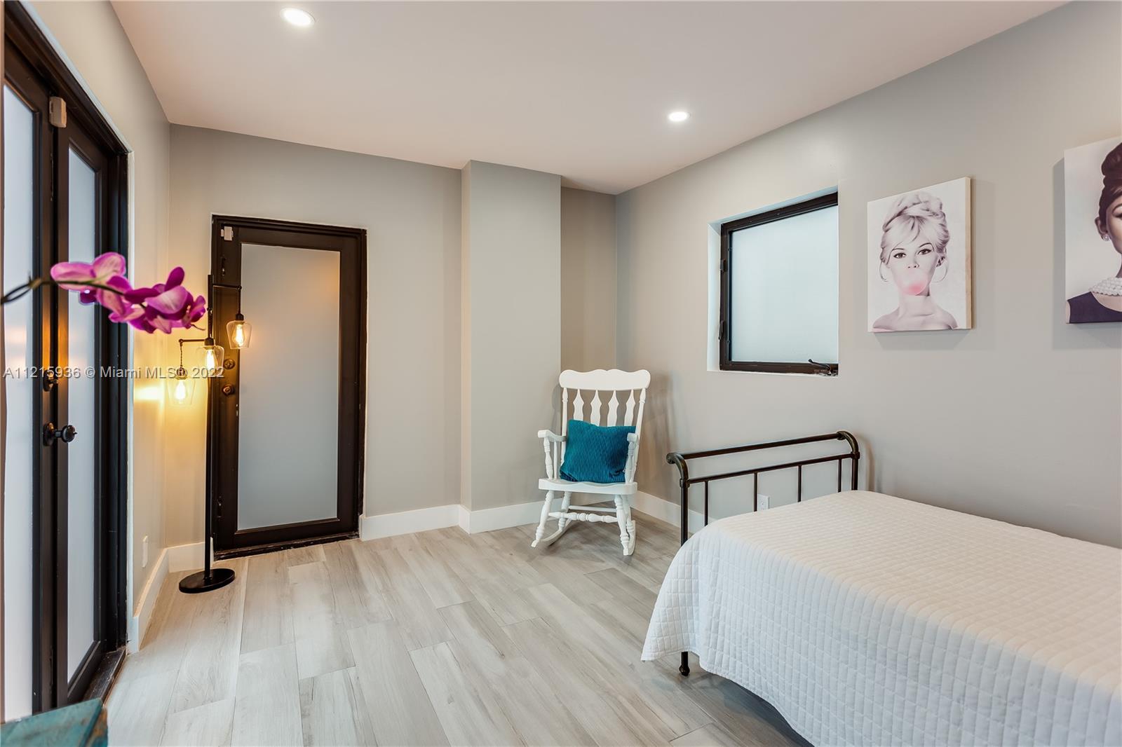 5135 Alton Road Miami Beach, FL 33140 - Photo 23 of 23 a bedroom with a bed and a chair in it