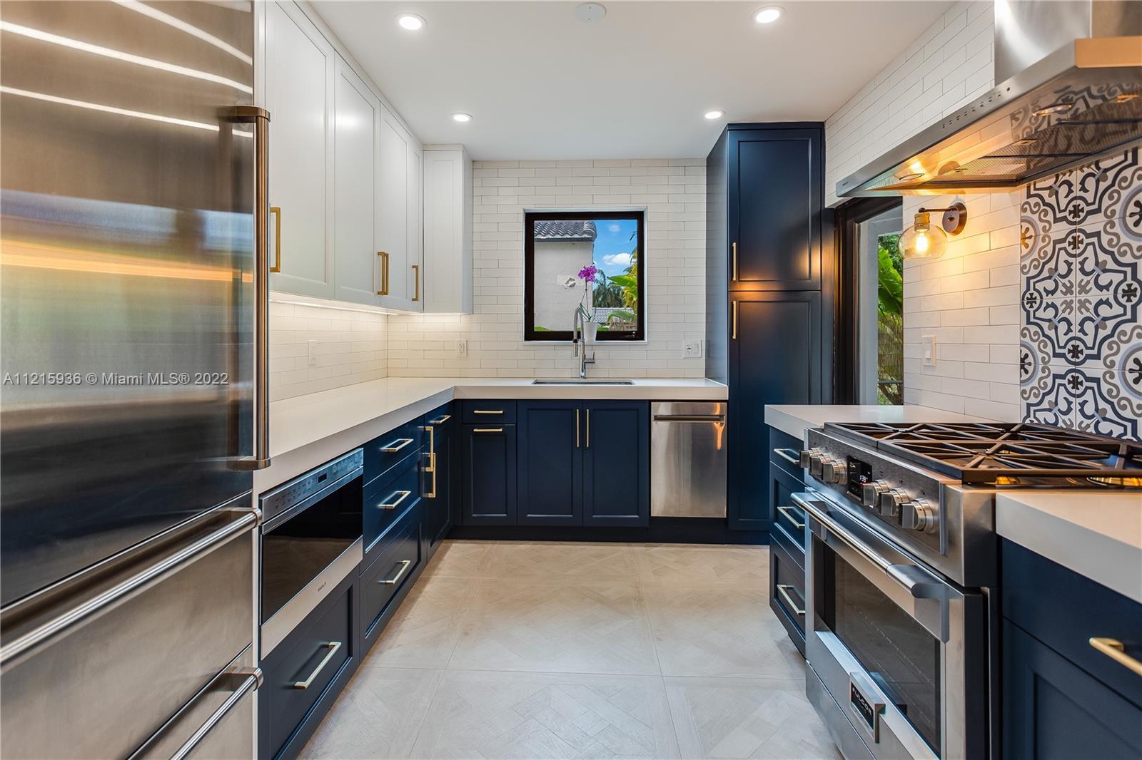 5135 Alton Road Miami Beach, FL 33140 - Photo 6 of 23 a large kitchen with stainless steel appliances granite countertop a stove and a sink