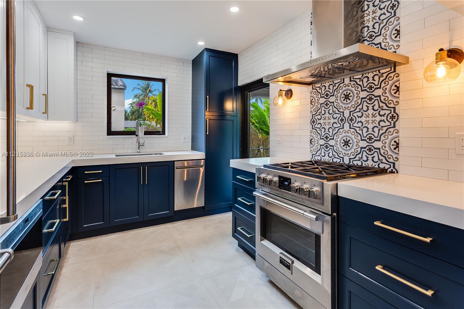 5135 Alton Road Miami Beach, FL 33140 - Photo 7 of 23 a kitchen with a stove and a sink