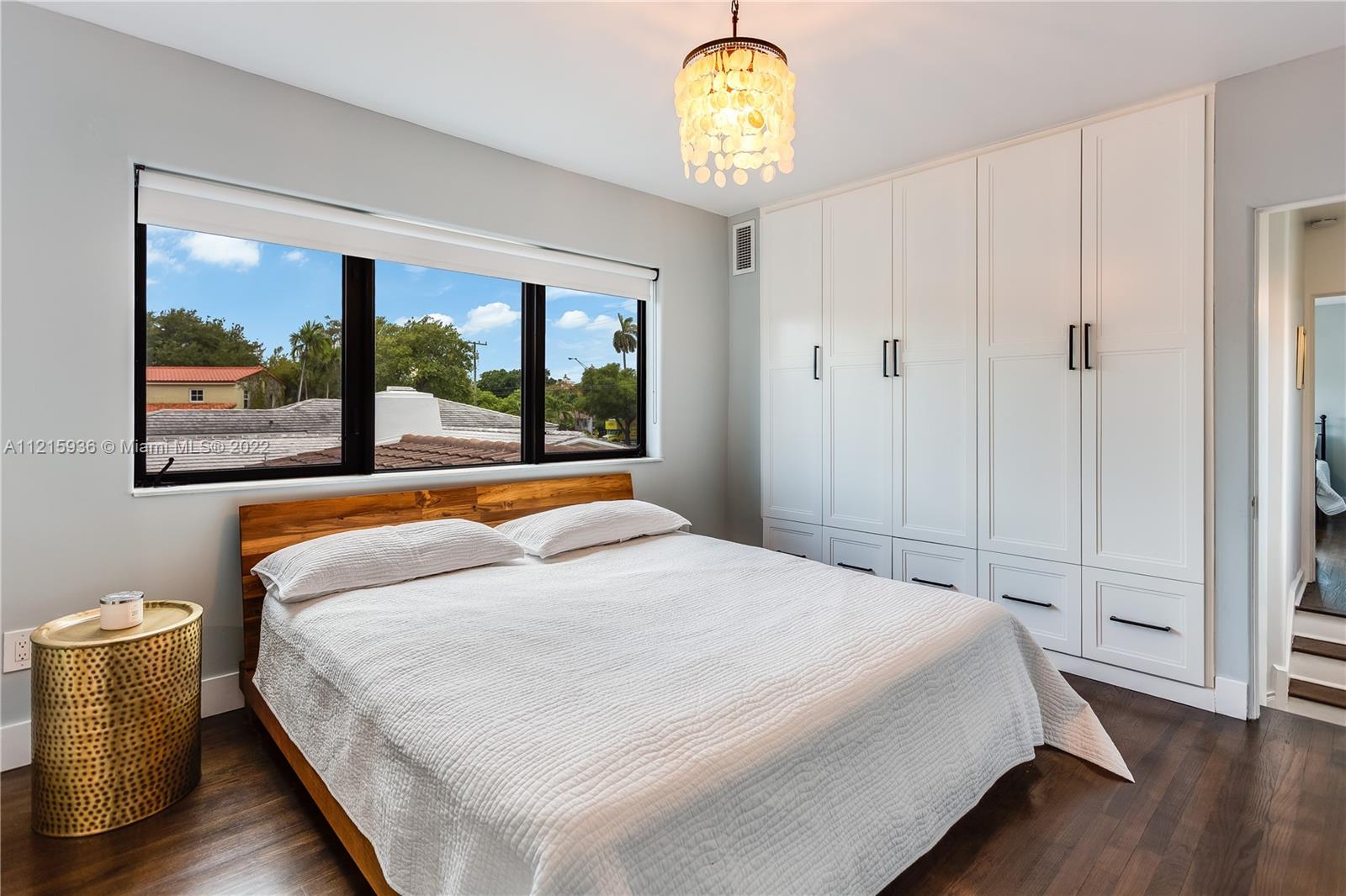 5135 Alton Road Miami Beach, FL 33140 - Photo 9 of 23 a bedroom with a large bed and a large window