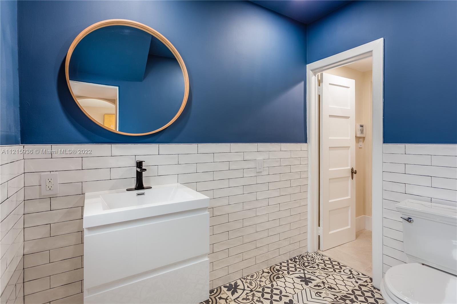5135 Alton Road Miami Beach, FL 33140 - Photo 10 of 23 a bathroom with a sink and a mirror