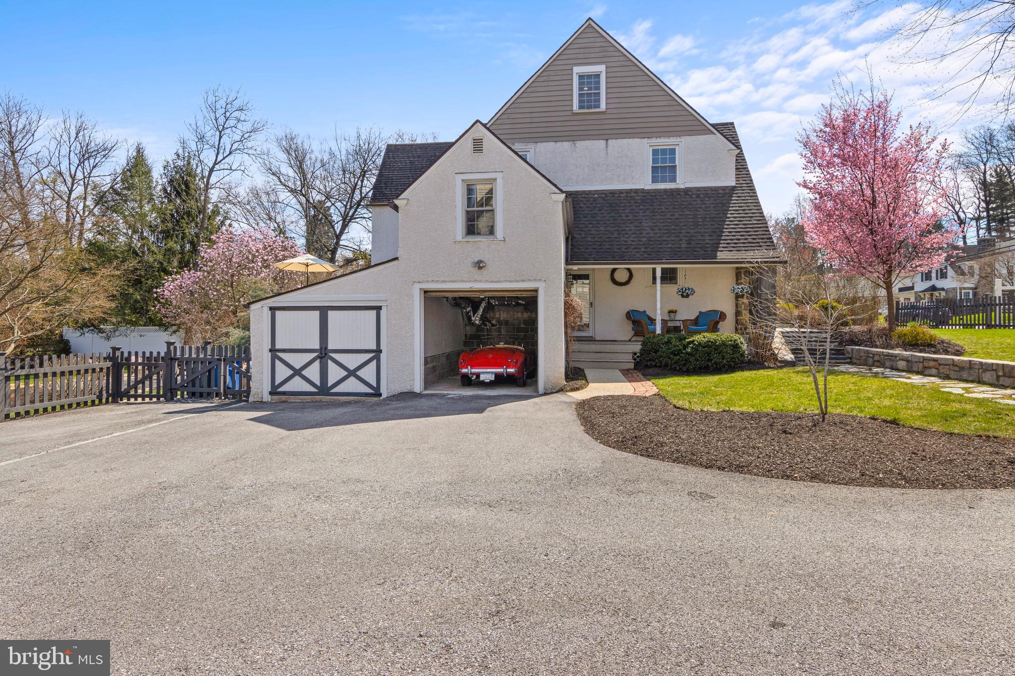321 Conestoga Road Wayne, PA 19087 - Photo 27 of 28 a front view of a house with a yard and garage