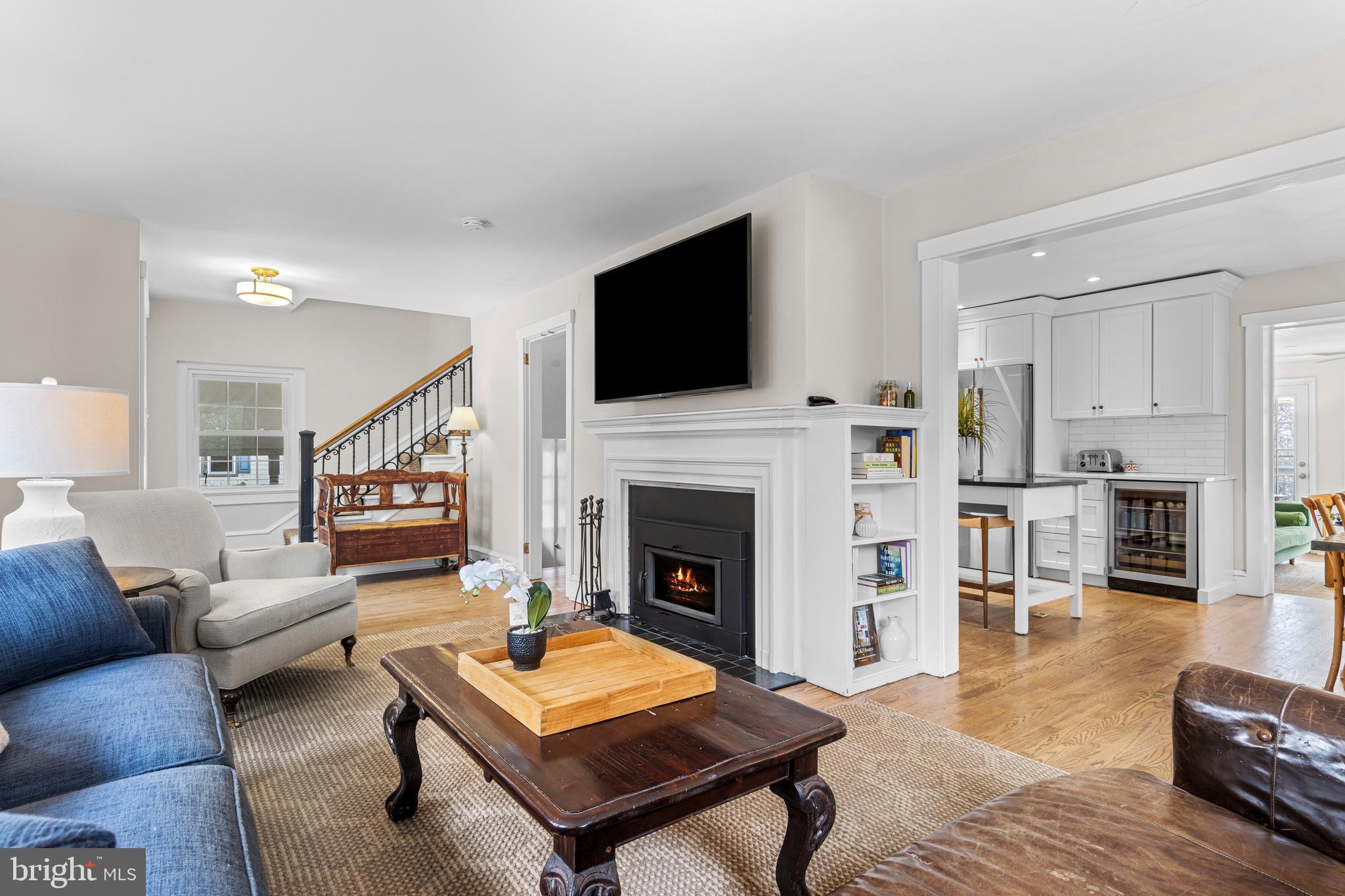 321 Conestoga Road Wayne, PA 19087 - Photo 6 of 28 a living room with furniture a fireplace and a flat screen tv