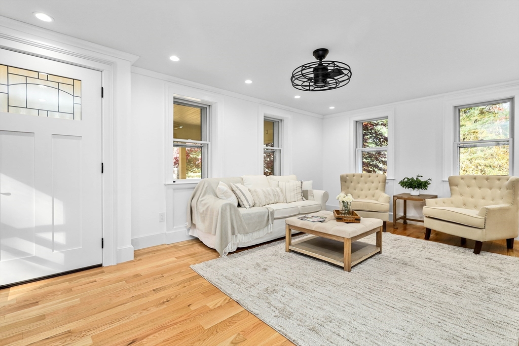 183 Burnt Swamp Road Wrentham, MA 02093 - Photo 3 of 38 a living room with furniture and a chandelier