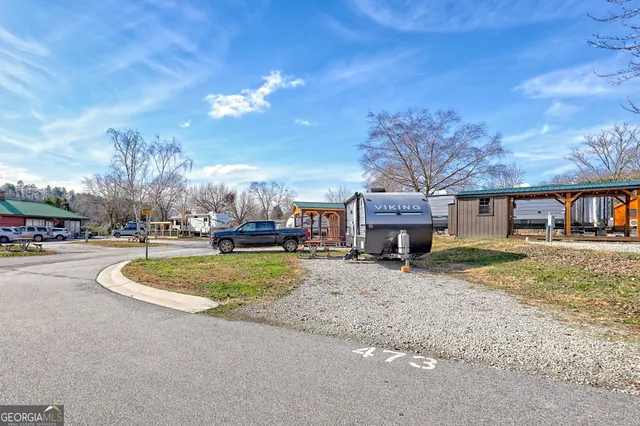 an aerial view of a house with swimming pool and a yard