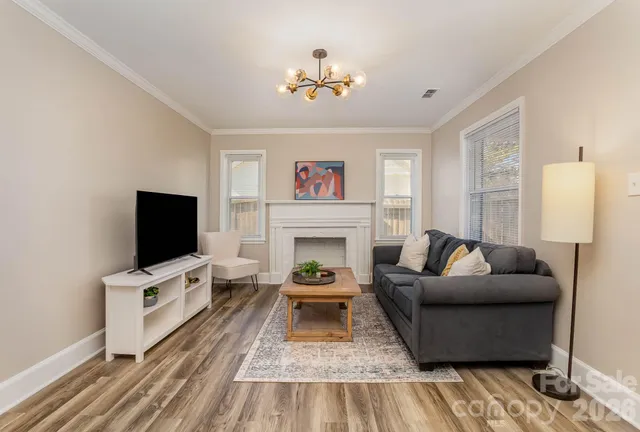 a living room with furniture a fireplace and a flat screen tv