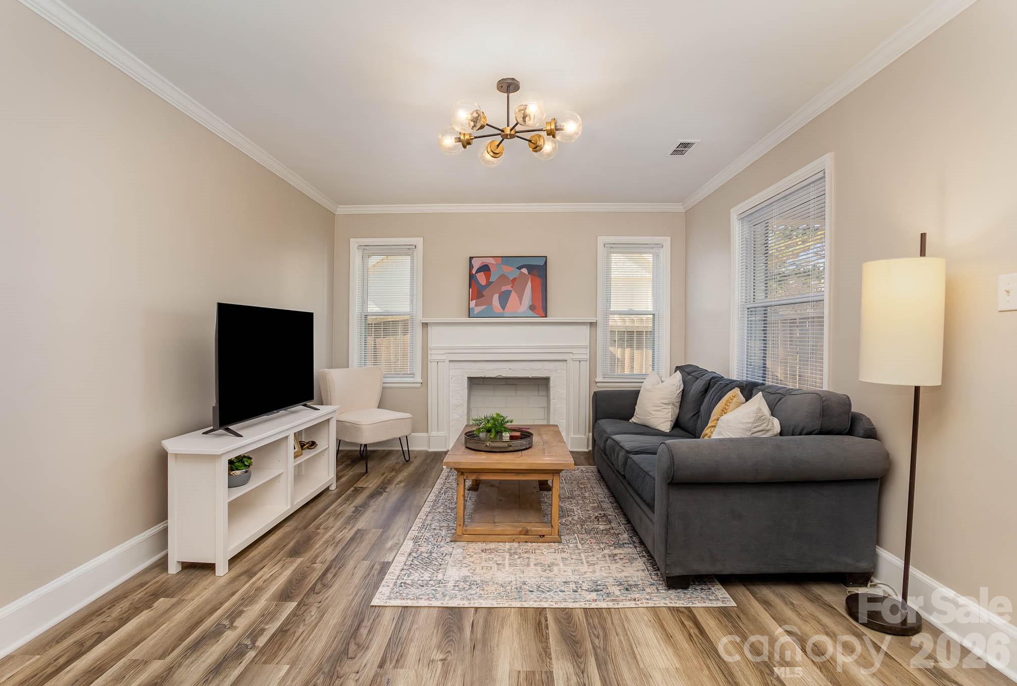 3141 Mathis Drive Charlotte, NC 28208 - Photo 3 of 12 a living room with furniture a fireplace and a flat screen tv