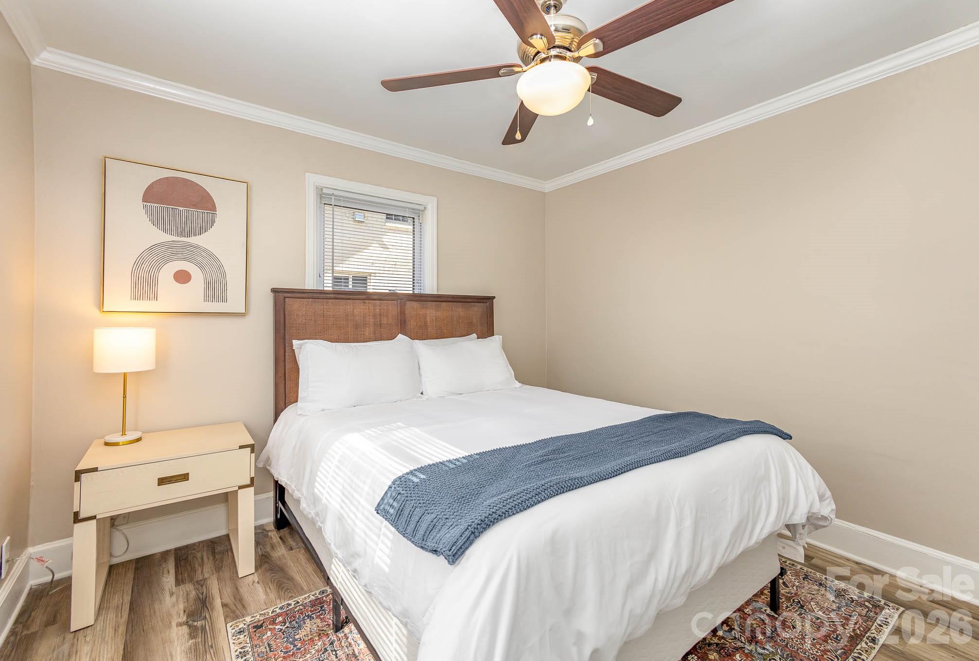 3141 Mathis Drive Charlotte, NC 28208 - Photo 7 of 12 a bedroom with a bed and a chandelier