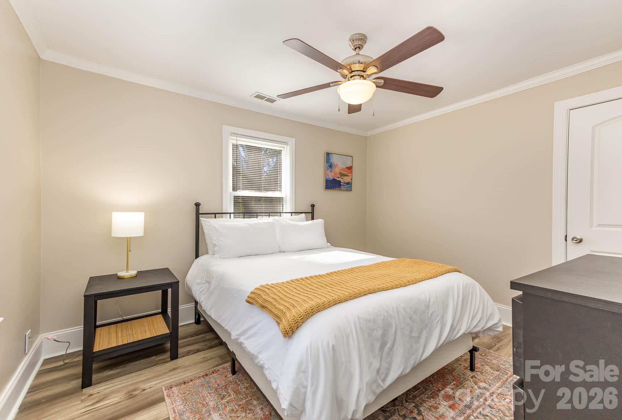 3141 Mathis Drive Charlotte, NC 28208 - Photo 9 of 12 a bedroom with a bed and a chandelier