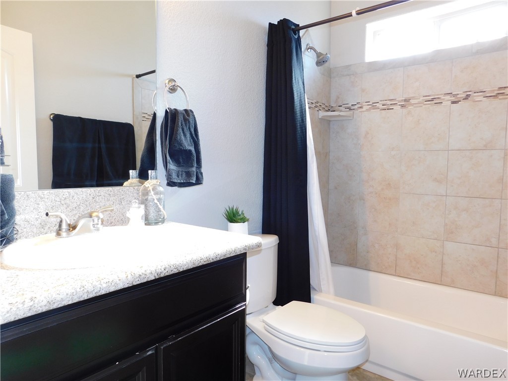 3370 South Ridge Avenue Bullhead City, AZ 86429 - Photo 42 of 56 a bathroom with a sink a toilet a mirror and shower