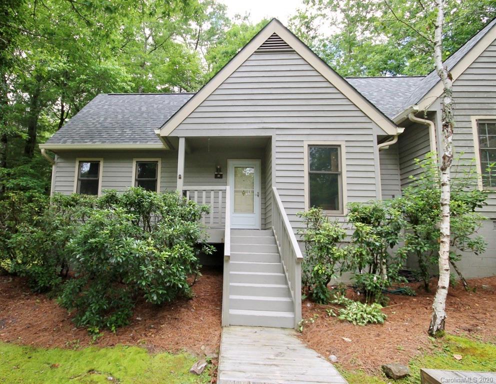 10 Dwarf Mountain Road, Unit 22 Sapphire, NC 28774 - Photo 1 of 23 a front view of a house with a yard