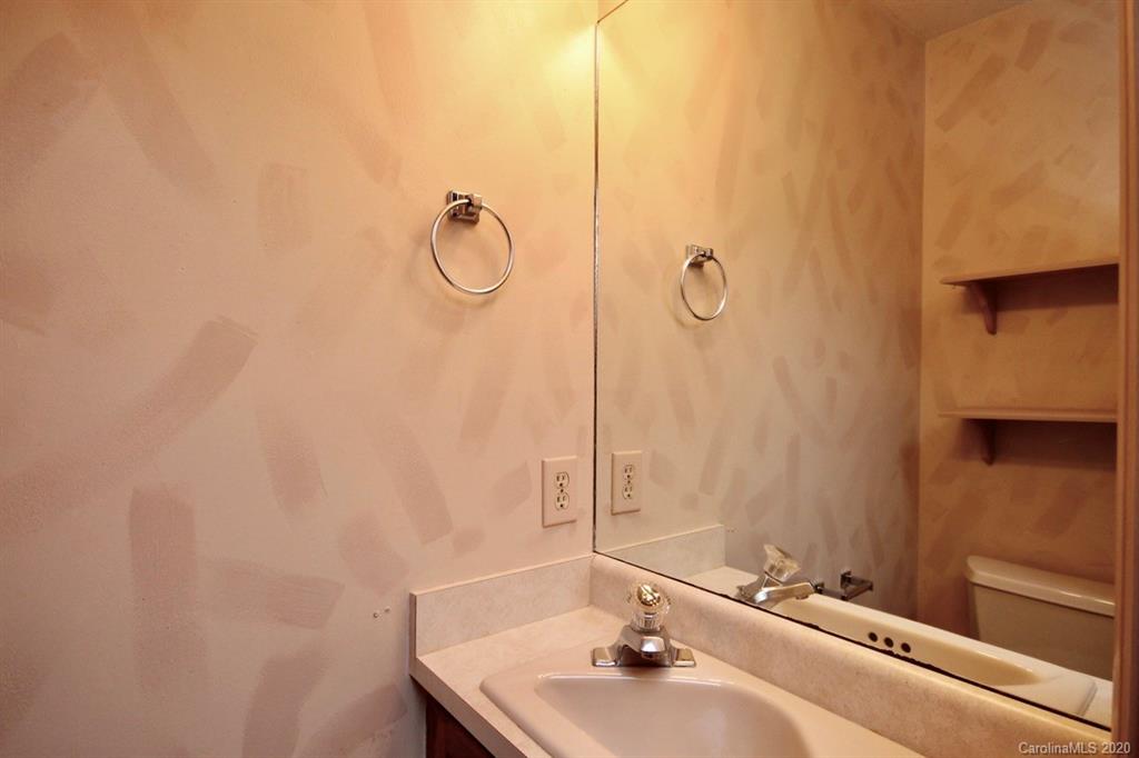 10 Dwarf Mountain Road, Unit 22 Sapphire, NC 28774 - Photo 14 of 23 a bathroom with a sink and mirror