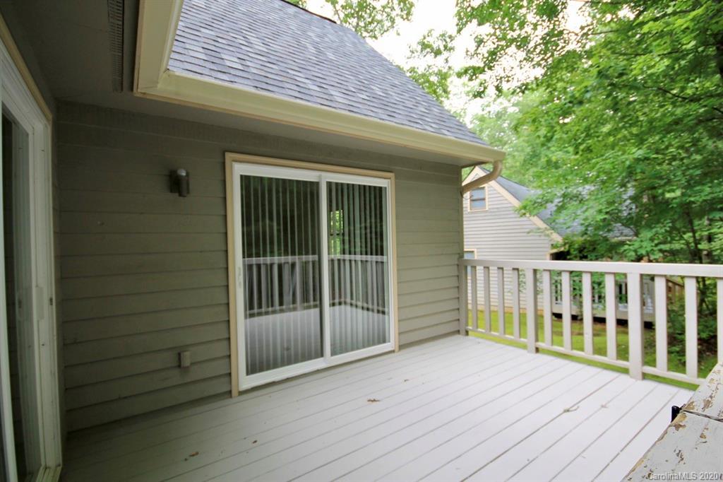 10 Dwarf Mountain Road, Unit 22 Sapphire, NC 28774 - Photo 20 of 23 a view of backyard with wooden deck and floor to ceiling window