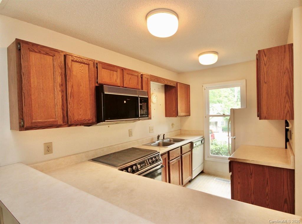 10 Dwarf Mountain Road, Unit 22 Sapphire, NC 28774 - Photo 6 of 23 a kitchen with stainless steel appliances granite countertop a sink stove and refrigerator