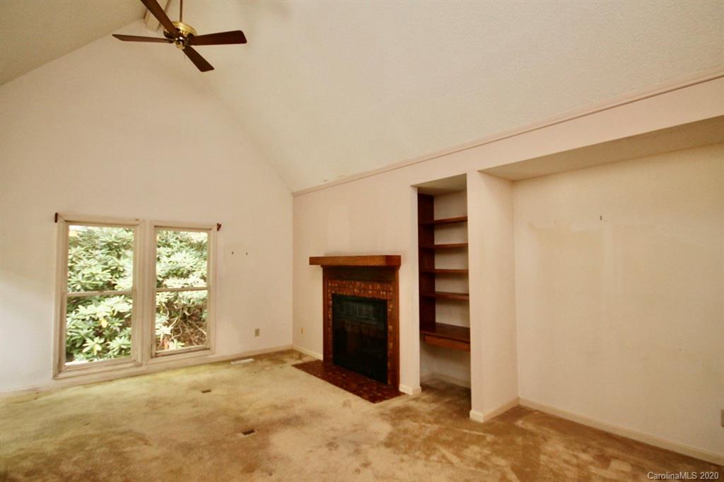 10 Dwarf Mountain Road, Unit 22 Sapphire, NC 28774 - Photo 9 of 23 a view of an empty room with a fireplace and a window