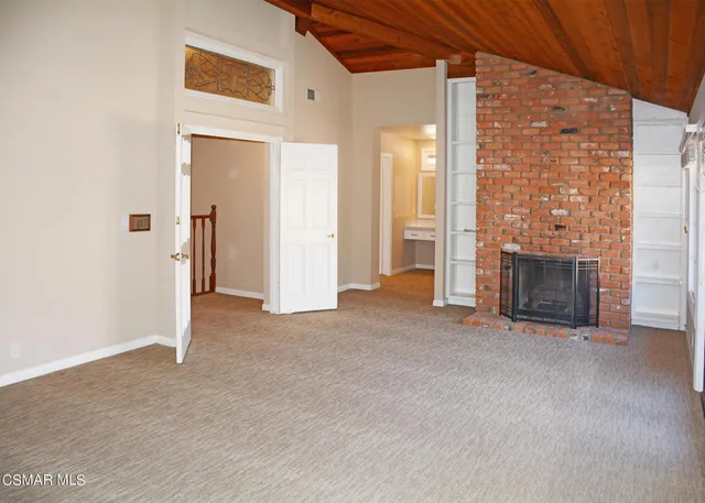 an empty room with fireplace