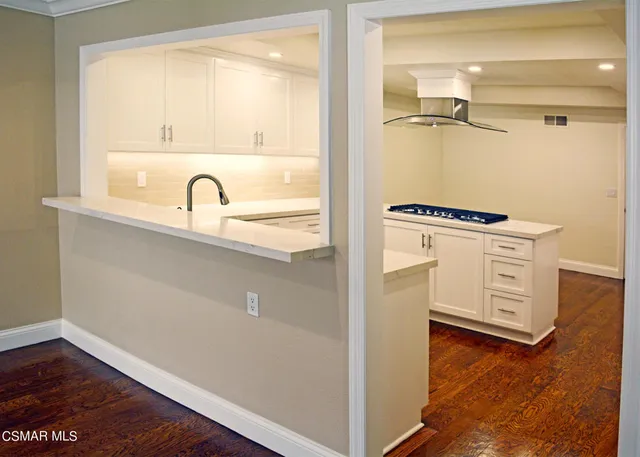 a close view of a refrigerator a stove a sink and a window